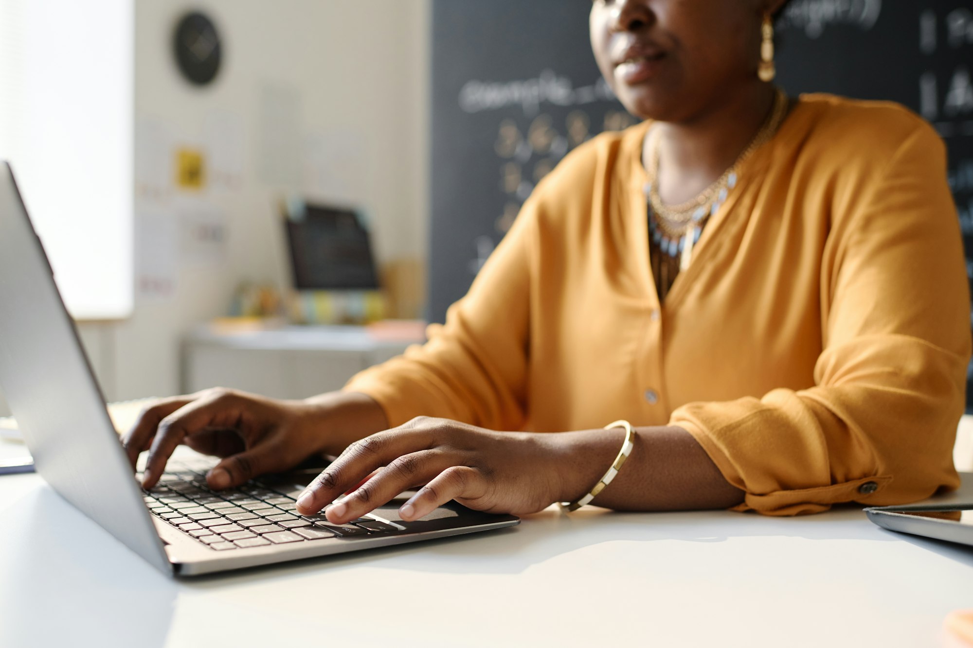 Teacher working on laptop at school