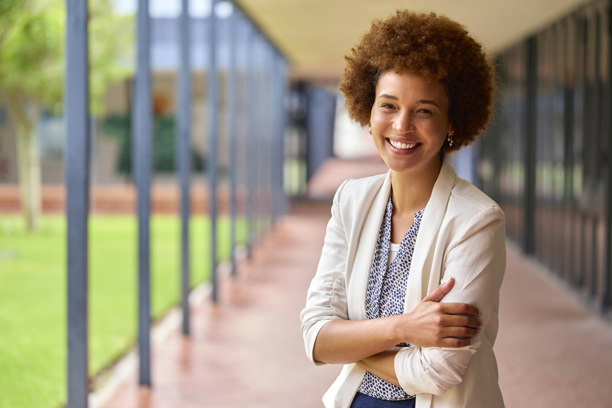 Portrait Of Smiling Female Elementary School Teacher Outdoors At School