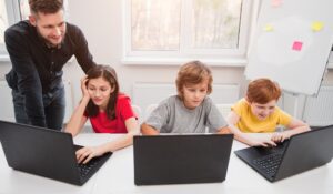 Kids having computer science lesson in classroom