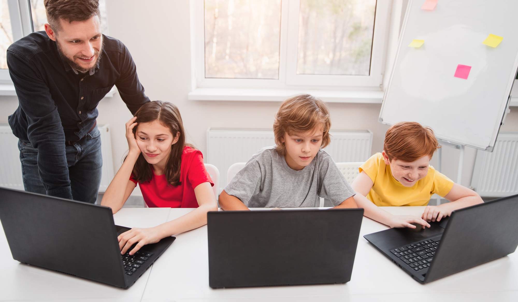 Kids having computer science lesson in classroom