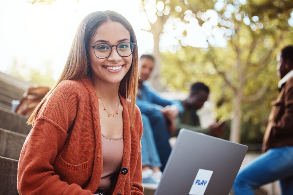 Student with laptop, woman with smile in portrait, university and education, scholarship and outdoo